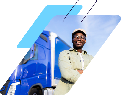 commercial driver smiling in front of semi with arms crossed